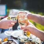 People cheers'ing glasses of LBW wine at a picnic