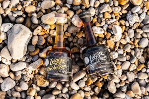 Bottles of Jack lugger rum on a stony beach